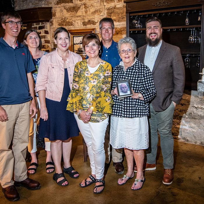 Ambros Amby Johnson family holding a picture of him